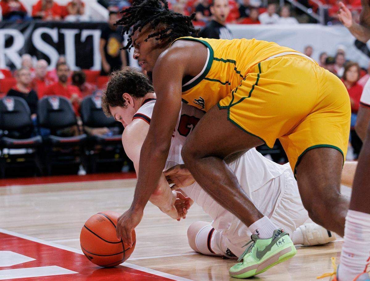 N.C. State’s Ben Middlebrooks and Lees-McRae’s Dre Nelson dive after the ball during the second half of the Wolfpack’s 79-75 exhibition win on Wednesday, Oct. 30, 2024, at the Lenovo Center.