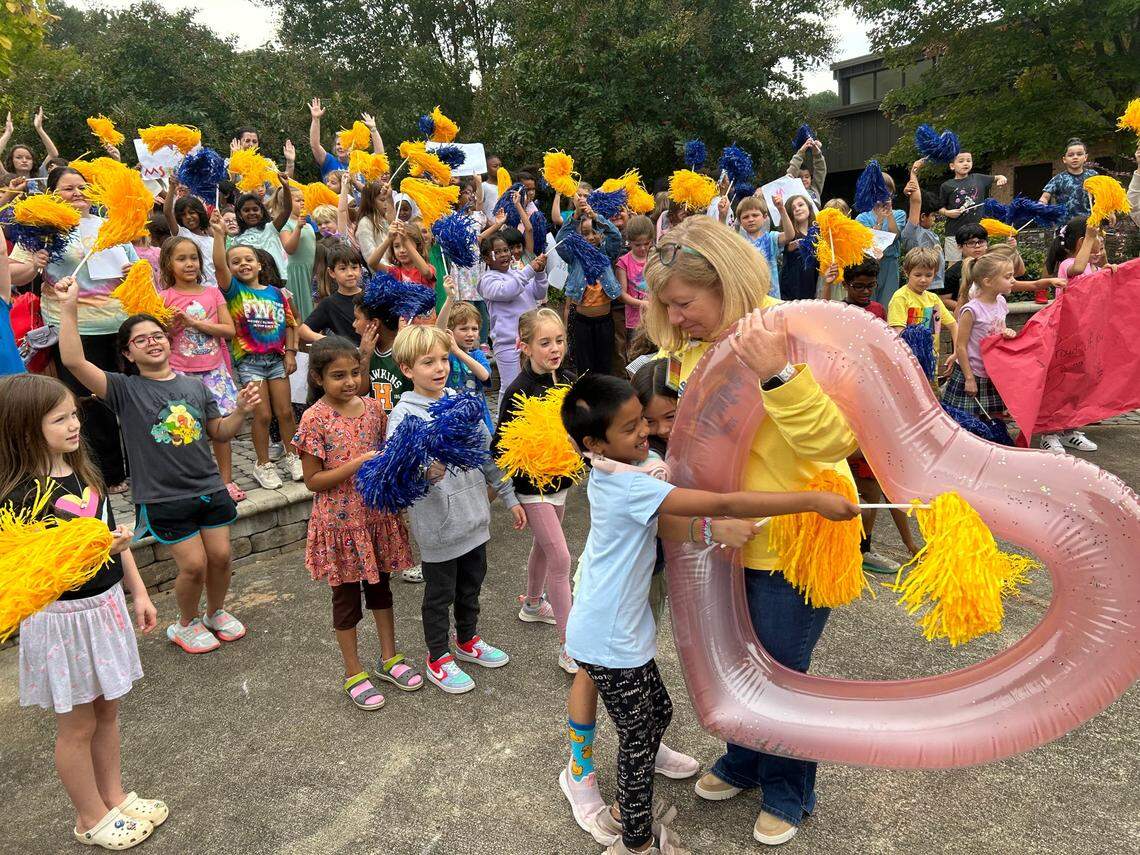 Students at Farmington Woods Elementary School in Cary, N.C., rush up to Winston Pierce on Oct. 6, 2023 to celebrate her being named Wake County’s 2023-24 Principal of the Year.