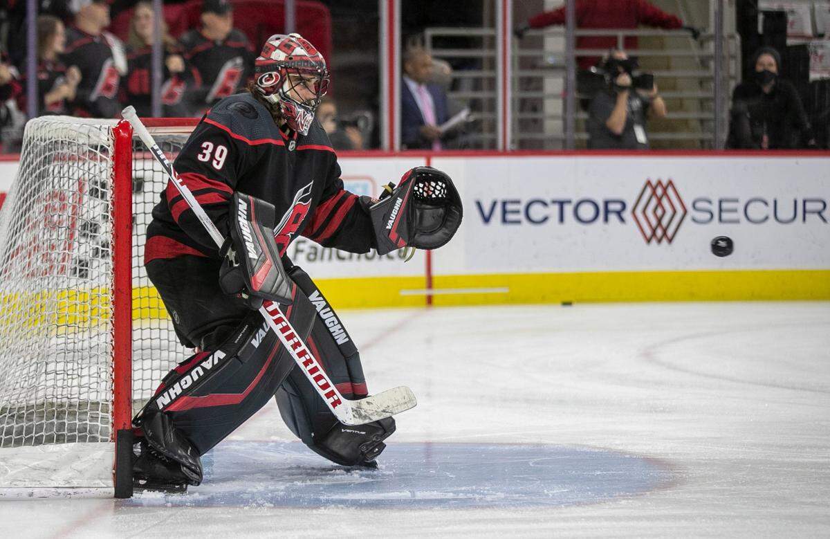 Carolina Hurricanes goalie Alex Nedeljkovic (39) deflects shots during pre-game warm up prior to game five of their Stanley Cup series against Tampa Bay on Tuesday, June 8, 2021 at PNC Arena in Raleigh, N.C.