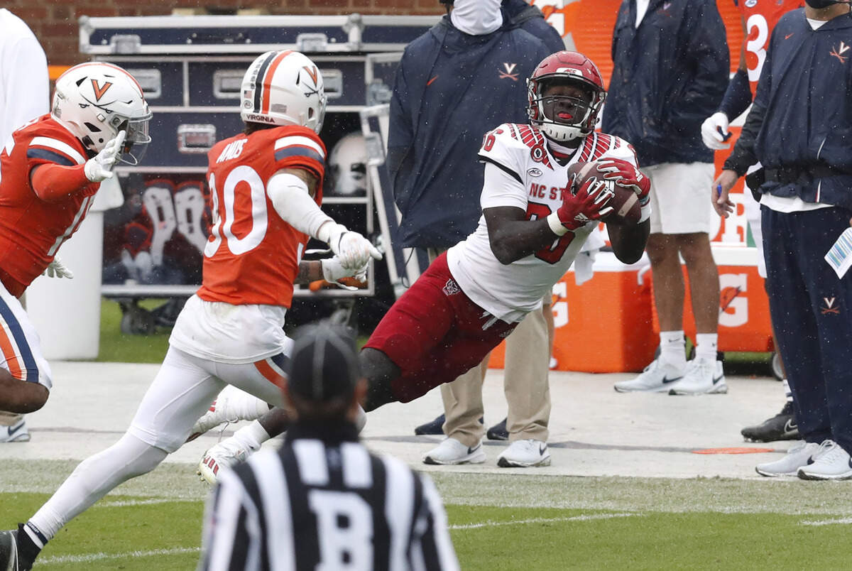 N.C. State wide receiver Emeka Emezie (86) makes the catch as Virginia safety D’Angelo Amos (30) trails during the second half of N.C. State’s 38-21 victory over Virginia at Scott Stadium in Charlottesville, Va., Saturday, Oct. 10, 2020.