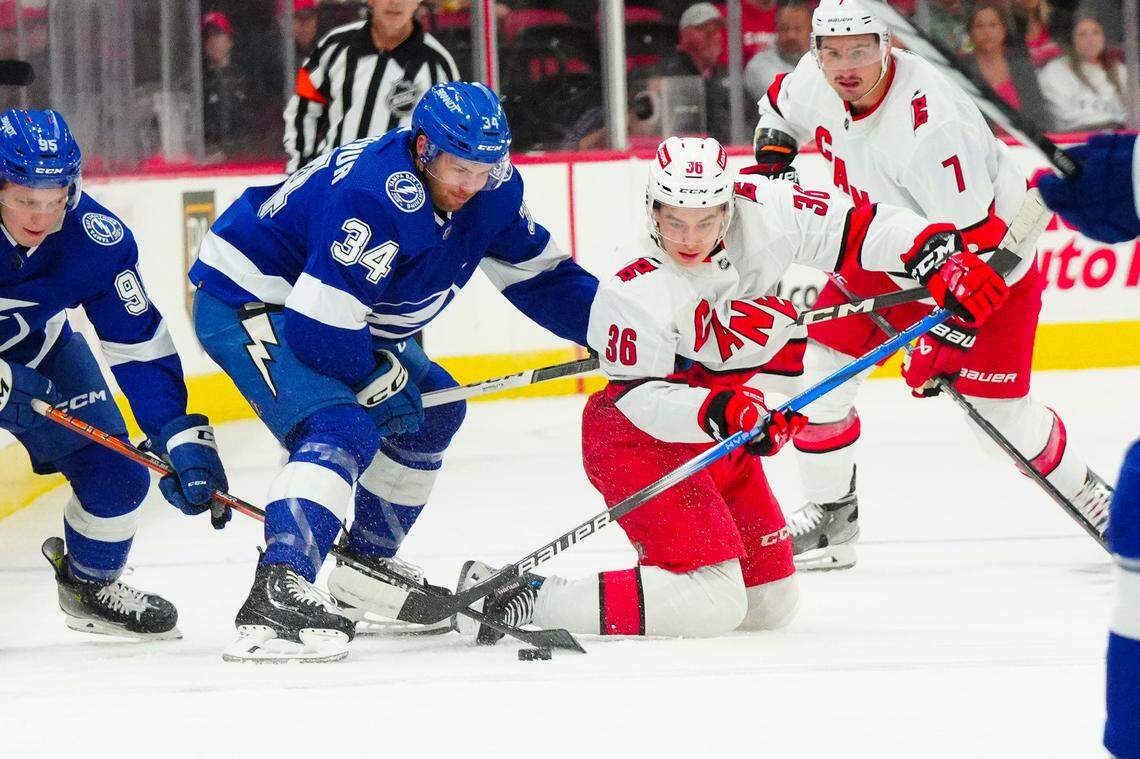 Sep 26, 2023; Raleigh, North Carolina, USA; Carolina Hurricanes forward Felix Unger Sorum (36) battles for the puck against Tampa Bay Lightning left wing Bennett MacArthur (343) during the first period at PNC Arena. Mandatory Credit: James Guillory-USA TODAY Sports