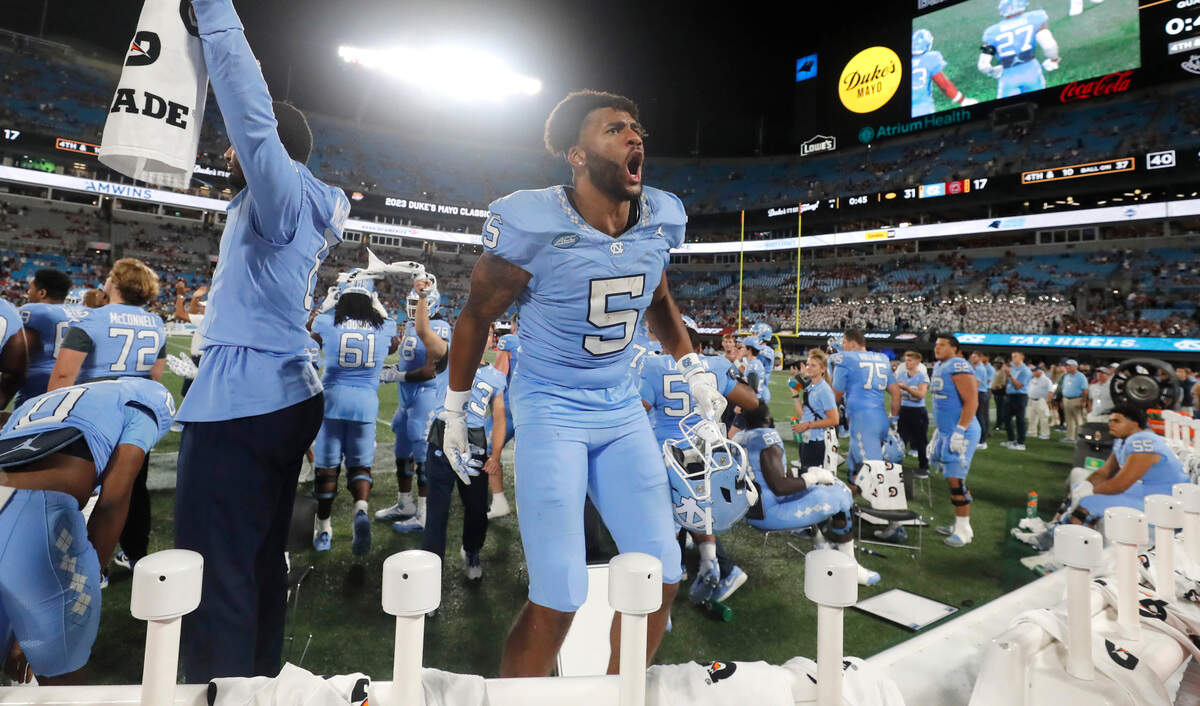 North Carolina wide receiver J.J. Jones (5) encourages crowd as time runs out in UNC’s 31-17 victory over South Carolina in the Duke’s Mayo Classic at Bank of America Stadium in Charlotte, N.C., Saturday, Sept. 2, 2023.