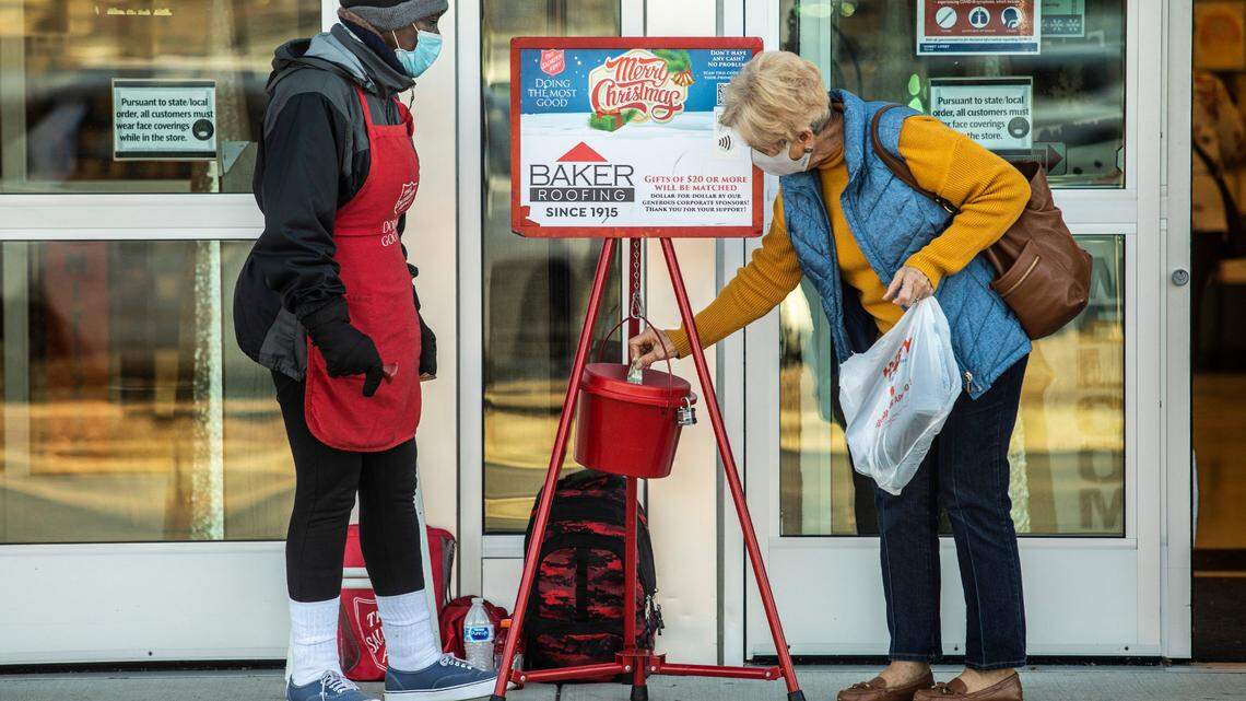 Ernestine McDade, a Salvation Army bell ringer, accepts donations from shoppers at Hobby Lobby on Capital Boulevard in Raleigh Friday, Nov. 20, 2020.