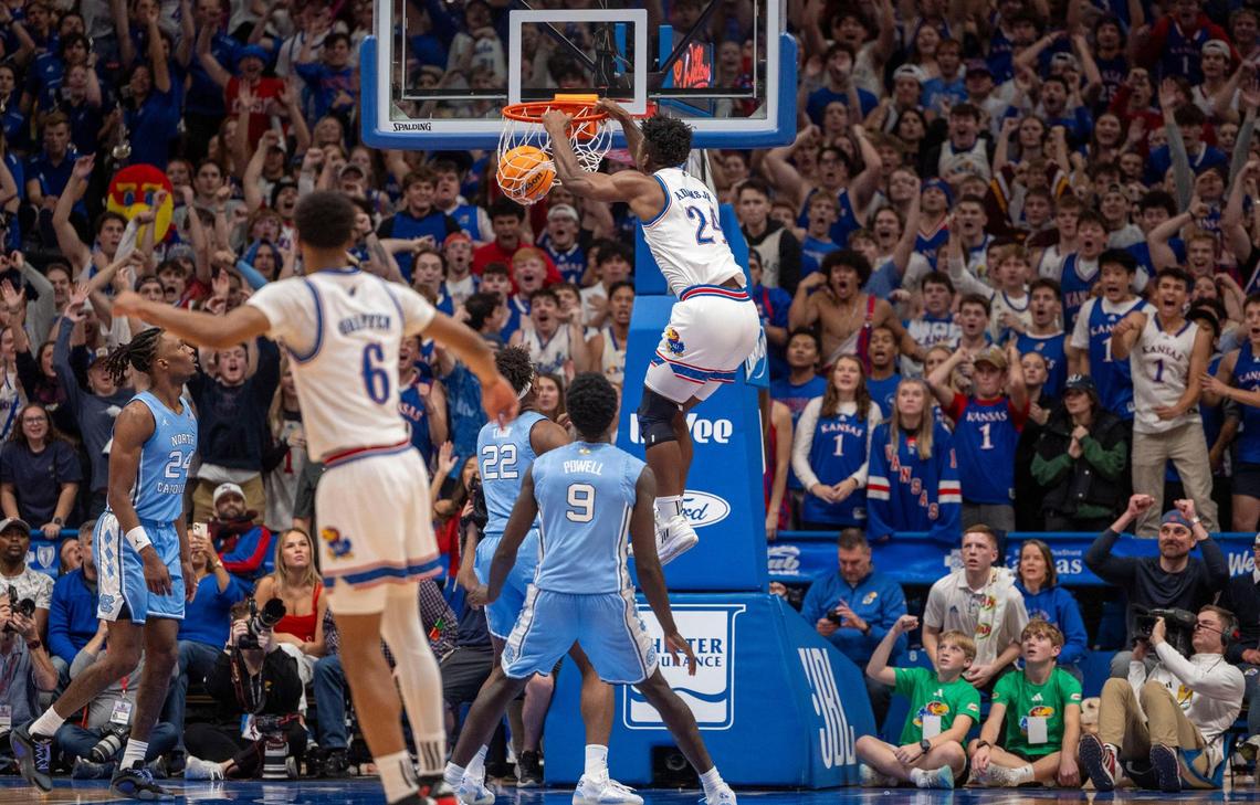 Kansas forward K.J. Adams Jr. (24) dunks over North Carolina’s Ven-Allen Lubin (22) and Drake Powell (9) in the first half against on Friday, November 8, 2024 at Allen Fieldhouse in Lawrence, Kansas.