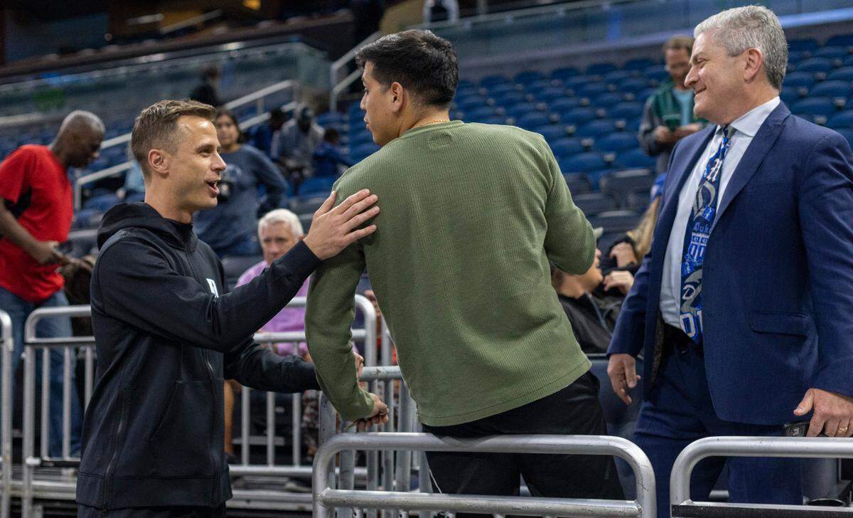 Duke head coach Jon Scheyer talks with fans following the Blue Devils’ practice on Wednesday, March 15, 2023 at the Amway Center in Orlando, Fla.