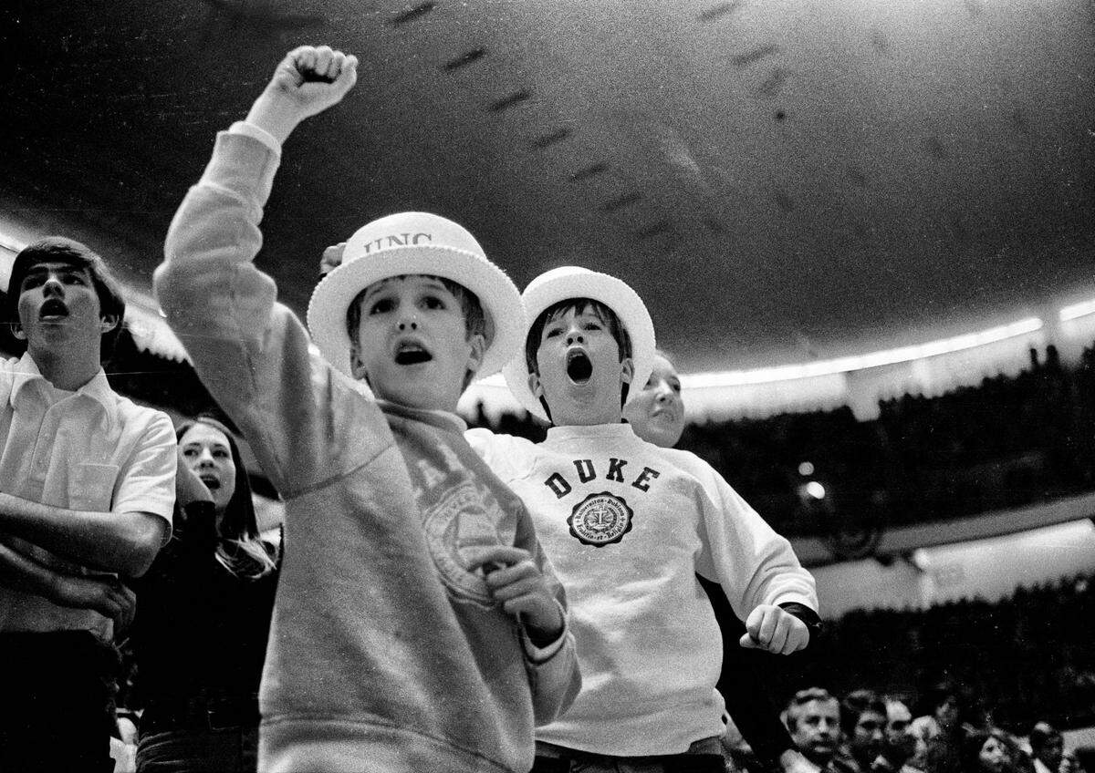 Young UNC and Duke fans cheer on the Blue Devils at the 1972 ACC Tournament in Greensboro.