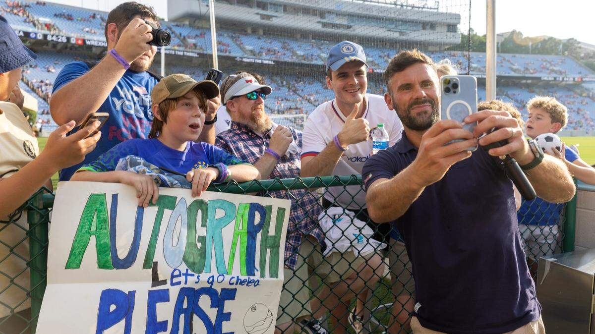 Wrexham goalkeeper Ben Foster take selfies and signs autographs for fans prior to their match against Chelsea on Wednesday, July 19, 2023 in Kenan Stadium in Chapel Hill, N.C.