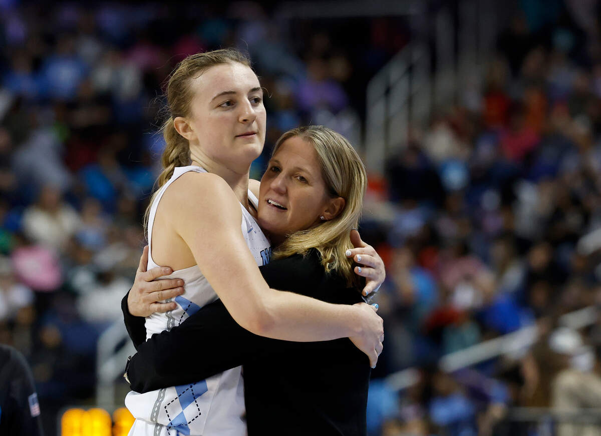 North Carolina’s Alyssa Ustby and head coach Courtney Banghart hug in the closing seconds of the Tar Heels’ 78-71 win over Boston College in the ACC Tournament on Thursday, March 6, 2025, at First Horizon Coliseum in Greensboro, N.C.