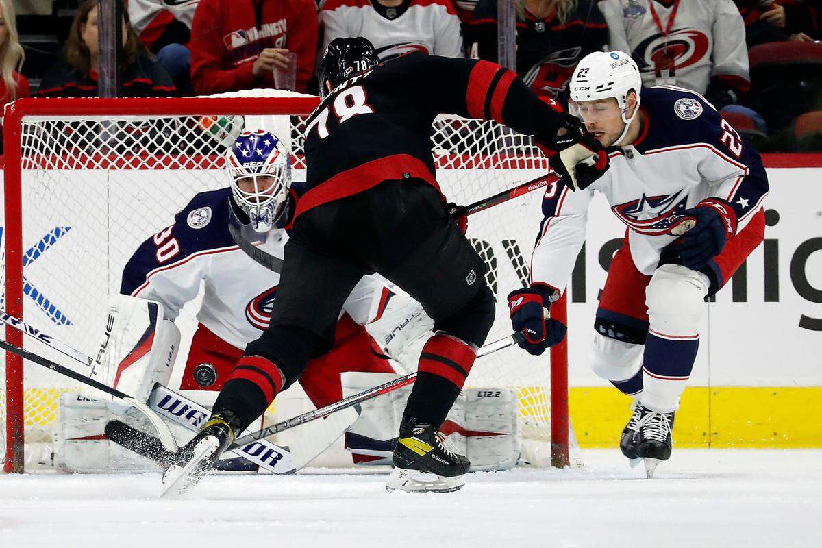 Carolina Hurricanes’ Steven Lorentz (78) tries to shoot the puck past Columbus Blue Jackets goaltender J-F Berube (30) with Blue Jackets’ Brendan Gaunce (23) nearby during the first period of an NHL hockey game in Raleigh, N.C., Friday, Feb. 25, 2022. (AP Photo/Karl B DeBlaker)