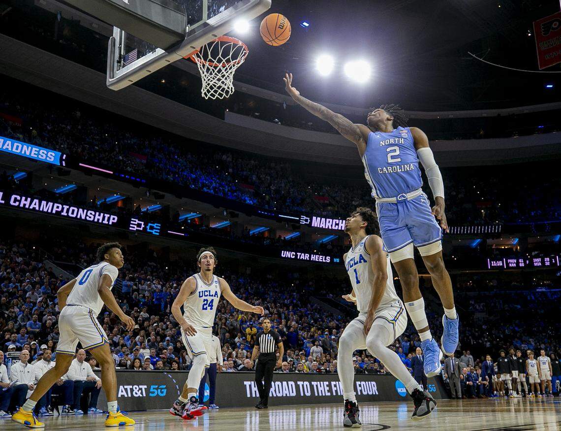 North Carolina’s Caleb Love (2) slashes through UCLA ’s Jules Bernard (1), Jaime Jaquez Jr. (24) and Jaylen Clark (0) for two of his game high 30 points during the second half on Friday, March 25, 2022 during the NCAA East Regional semi-final at Wells Fargo Center in Philadelphia, Pa.