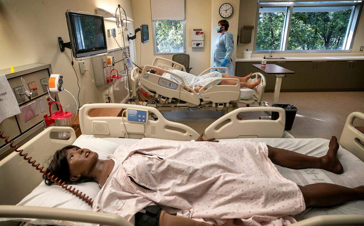 Wake Technical Community College nursing student Sam Teague monitors an anatomical dummy as he trains to care for COVID-19 patients on Friday, Oct. 1, 2021, at the Perry Health Sciences Campus in Raleigh, N.C.