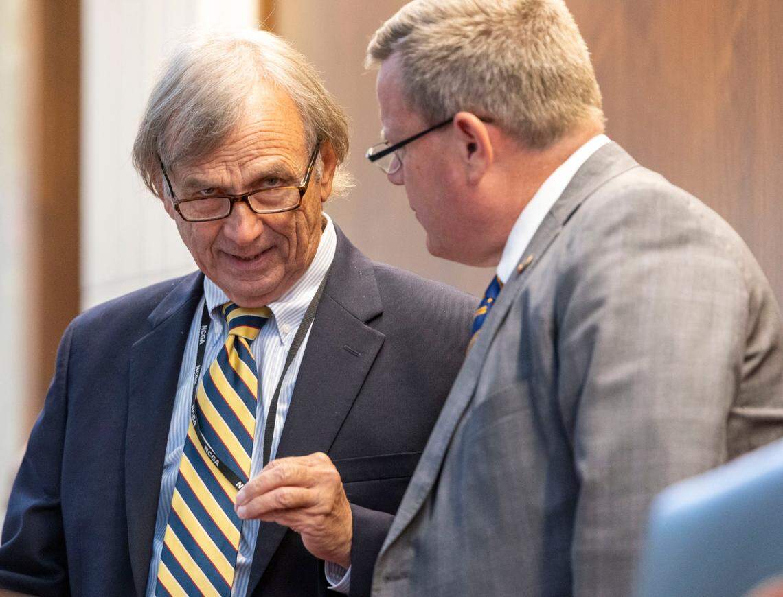 Sen. Bill Rabon confers with then-House Speaker Tim Moore on the dais in the House of Representatives during debate of the proposed state budget in the House on Thursday, June 30, 2022 in Raleigh, N.C.