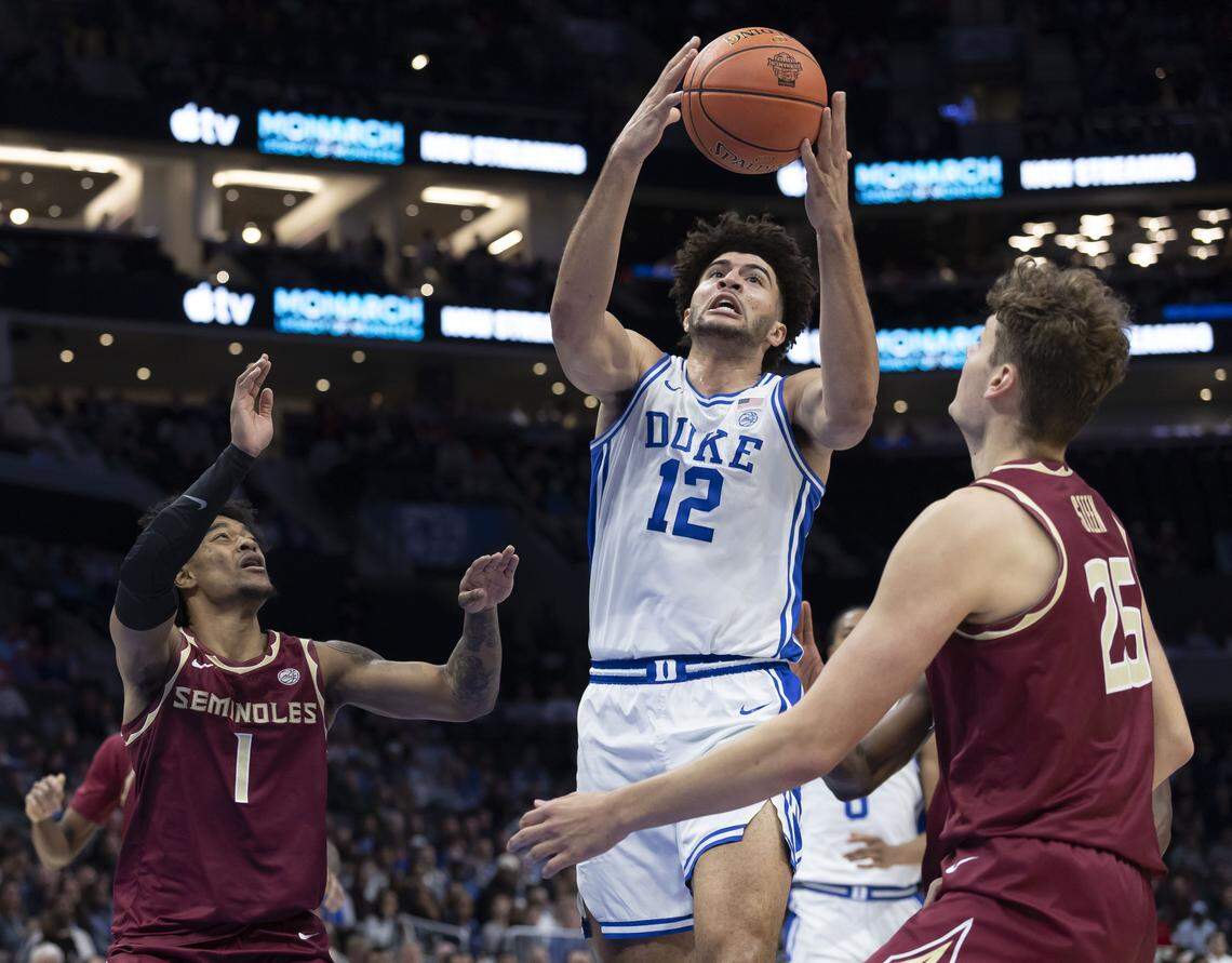 Duke forward Cameron Boozer (12) works to gain control of the ball between Florida State forwards Alex Steen (25) and guard Martin Somerville (1) in the first half on Thursday, March 12, 2026, during the quarterfinals of the ACC Tournament at Spectrum Center in Charlotte, N.C.