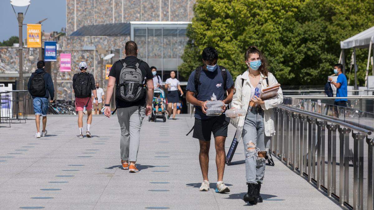 Students wearing masks walk through west campus at Duke University in Durham, N.C. on Tuesday, Aug. 31, 2021.