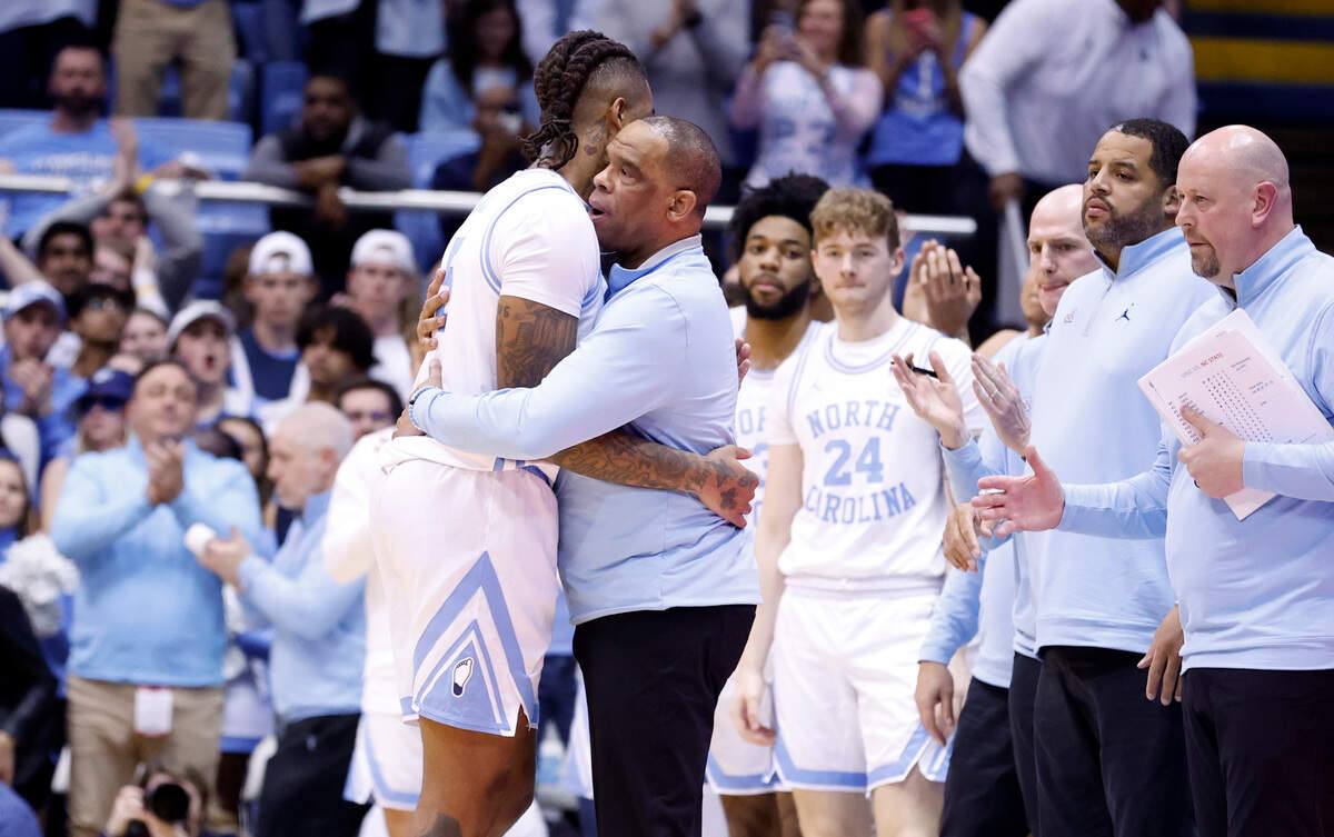 North Carolina head coach Hubert Davis hugs Armando Bacot (5) as he comes off the court late in the second half of UNC’s 80-69 victory over N.C. State at the Smith Center in Chapel Hill, N.C., Saturday, Jan. 21, 2023.