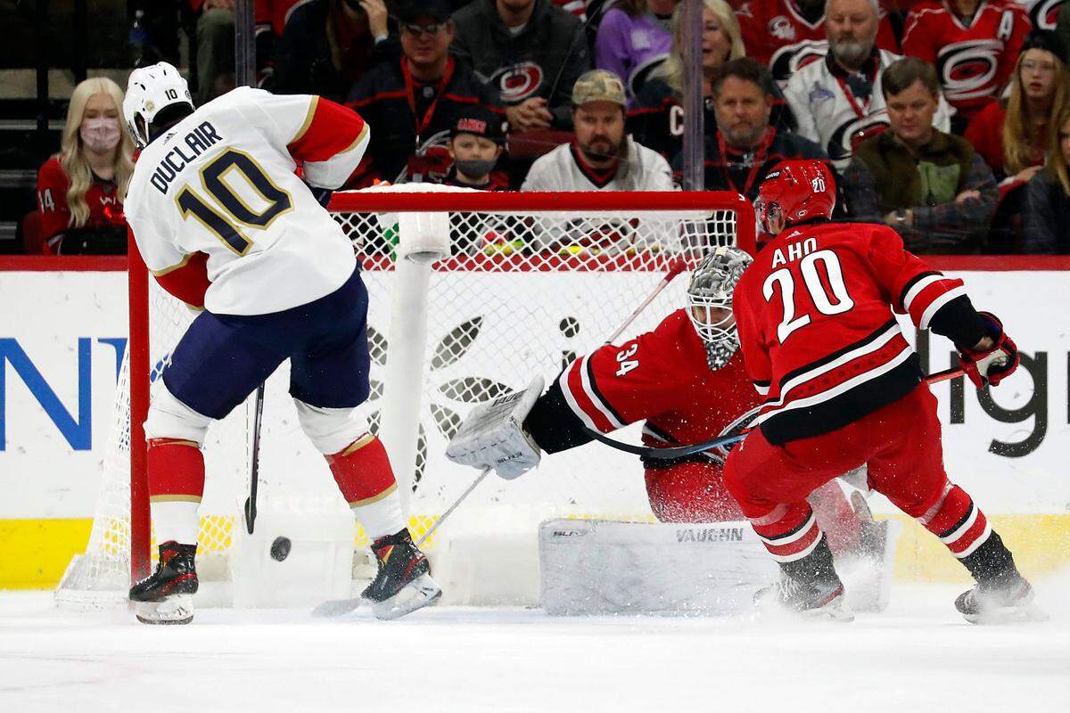 Florida Panthers’ Anthony Duclair (10) puts the puck in the net past Carolina Hurricanes goaltender Alex Lyon (34) with Hurricanes’ Sebastian Aho (20) nearby during the overtime period of an NHL hockey game in Raleigh, N.C., Saturday, Jan. 8, 2022. (AP Photo/Karl B DeBlaker)