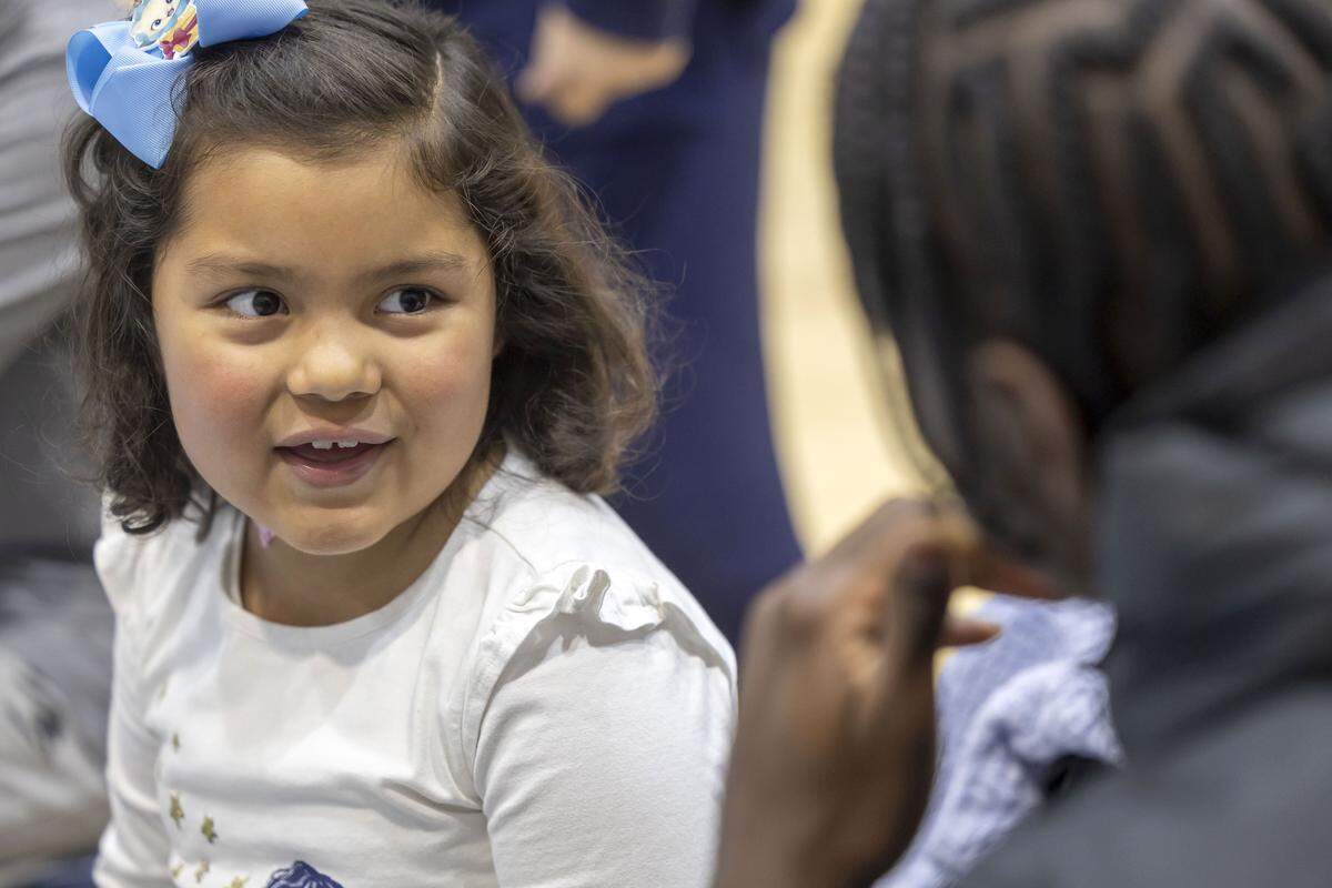 Six-year-old Sarah Ramirez of Raleigh, chats with North Carolina forward Caleb Wilson, during the Shoes 4 Hope event on Sunday, December 14, 2025 at the Smith Center in Chapel Hill, N.C.
