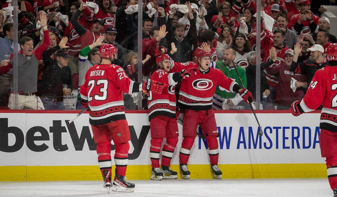 Carolina Hurricanes’ Sebastian Aho (20) celebrates with teammates Stefan Noesen (23) and Martin Necas (88) after scoring on New York Islanders goalie Ilya Sorokin (30) to take a 1-0 lead on Monday, April 17, 2023 at PNC Arena in Raleigh, N.C.