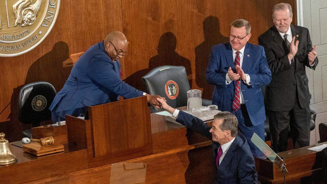 Gov. Roy Cooper shakes hands with Lt. Gov. Mark Robinson as House Speaker Tim Moore and Senate Leader Phil Berger look on before Cooper delivered his State of the State address to a joint session of the N.C. General Assembly on Monday, March 6, 2023.