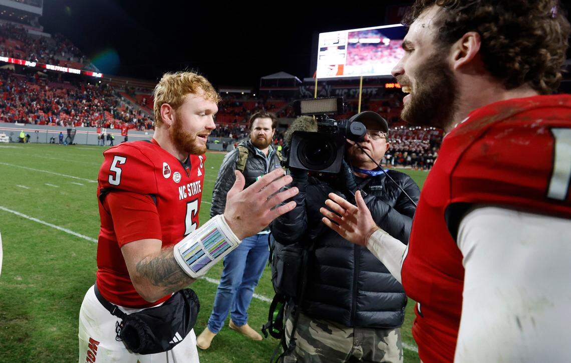 N.C. State linebacker Payton Wilson (11) celebrates with quarterback Brennan Armstrong (5) after N.C. State’s 39-20 victory over UNC at Carter-Finley Stadium in Raleigh, N.C., Saturday, Nov. 25, 2023.