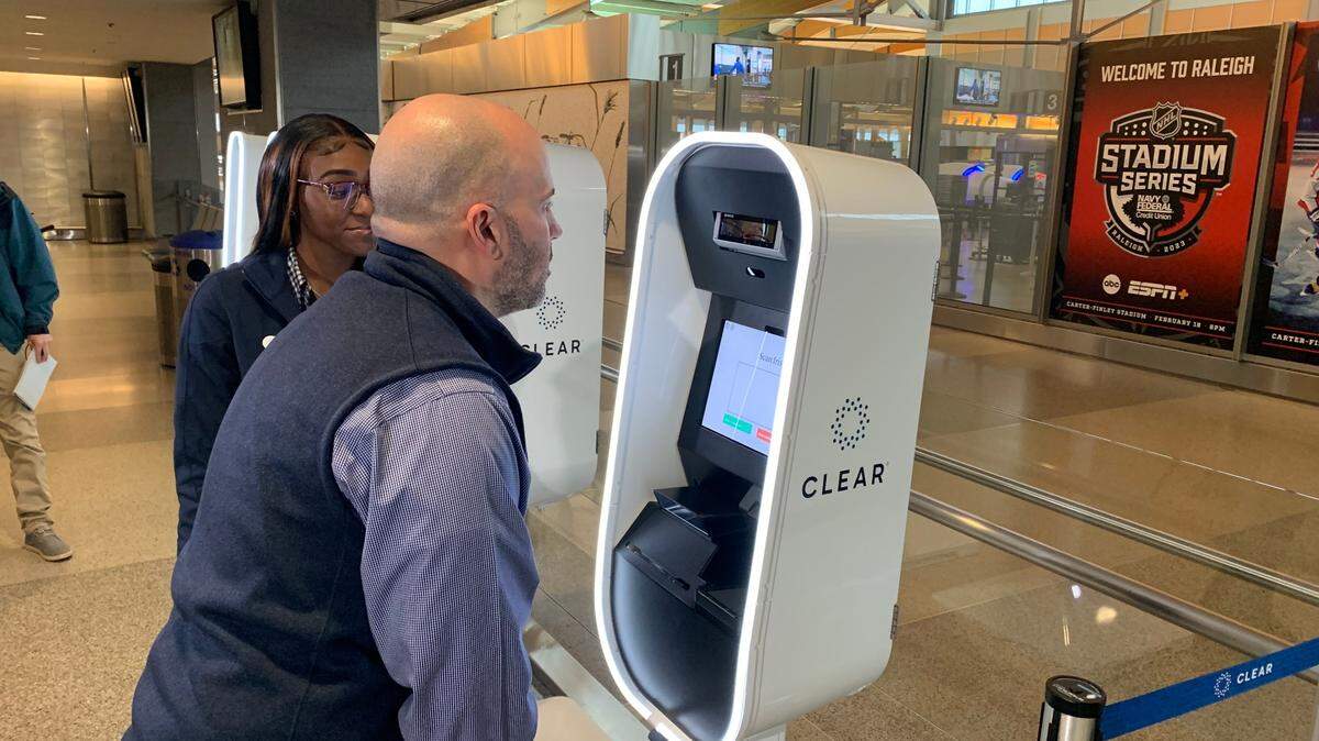 CLEAR employee Phillip Royer has his irises scanned as he demonstrates the process of enrolling in the company’s identification verification program, while Mya Faison looks on. Faison is a CLEAR ambassador who will assist customers at Raleigh-Durham International Airport.