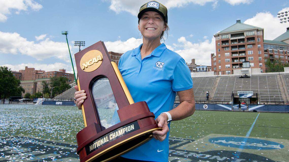 UNC women’s lacrosse head coach Jenny Levy holds the trophy for the NCAA National Championship title Sunday, May 29, 2022, after North Carolina defeated Boston College at Homewood Field at John Hopkins University. It’s UNC’s third NCAA championship.