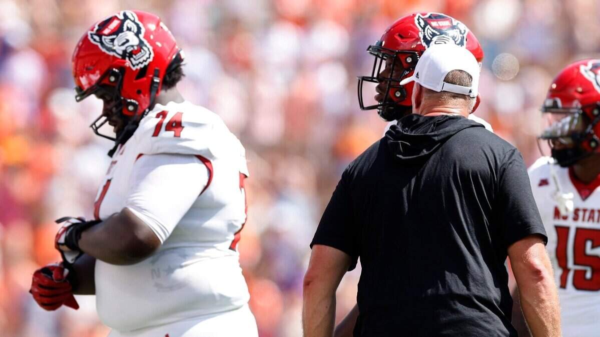 N.C. State head coach Dave Doeren yells at Anthony Belton (74) as he comes off the field after he was called for a penalty during the first half of N.C. State’s game against Clemson at Memorial Stadium in Clemson, S.C., Saturday, Sept. 21, 2024. Belton was ejected from the game.