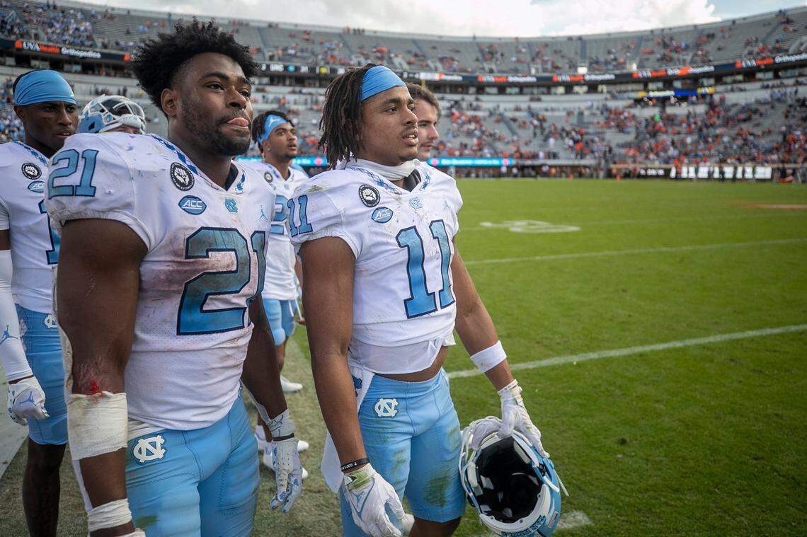 North Carolina’s Elijah Green (21) and Josh Downs (11) watch the final play from scrimmage as the Tar Heels secure their 31-28 victory over Virginia on Saturday, November 5, 2022 at Scott Stadium in Charlottesville, Va.