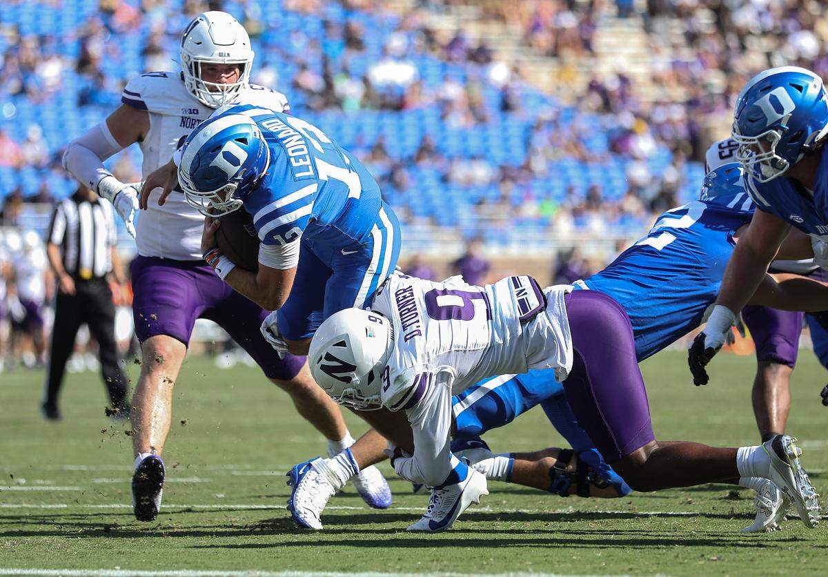 Duke quarterback Riley Leonard is brought down by Northwestern’s Devin Turner during the first half of the Blue Devils’ game against Northwestern on Saturday, Sept. 16, 2023, at Wallace Wade Stadium in Durham, N.C.