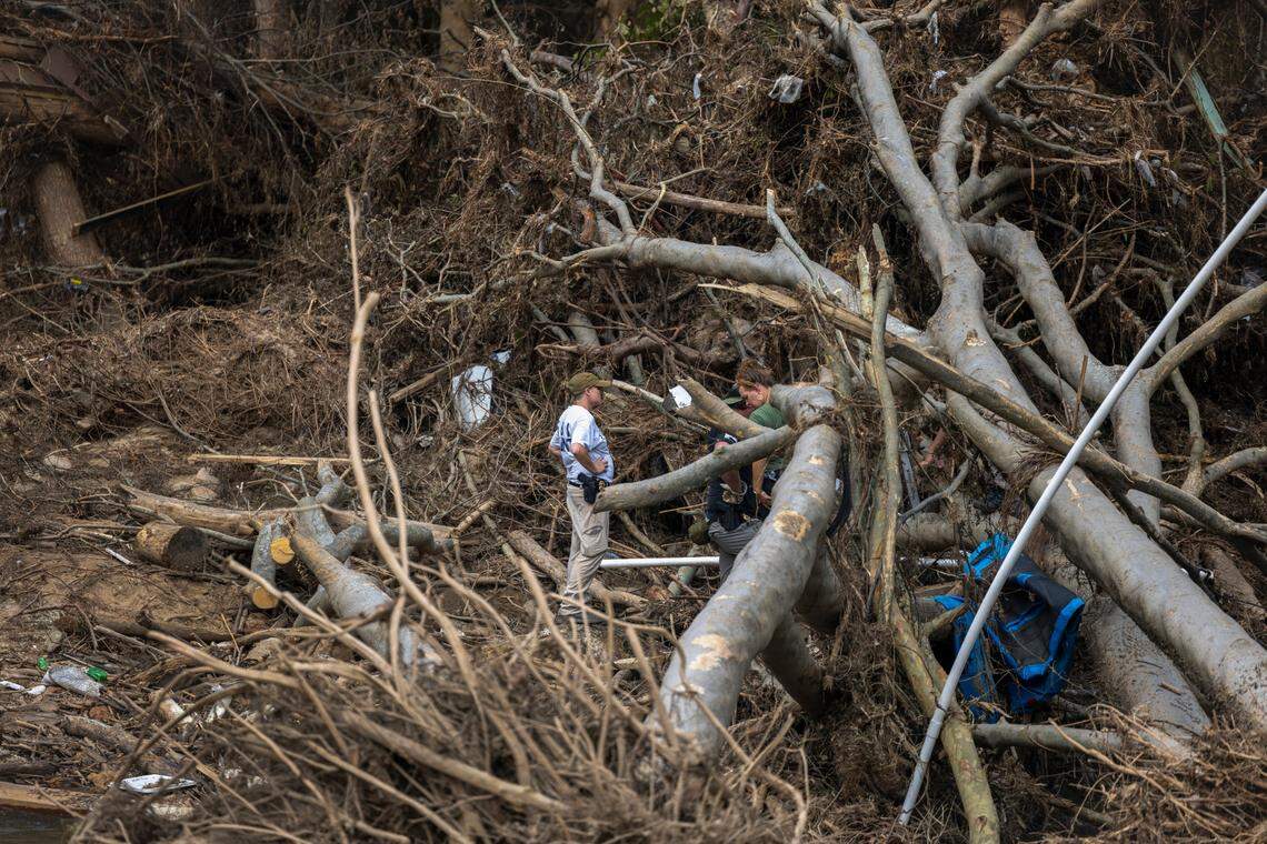 North Carolina SBI and Federal ATF Agents, search through storm debris in Spring Creek where it meets the French Broad River for victims of Hurricane Helene on Friday, October 4, 2024 in Hot Springs, N.C.