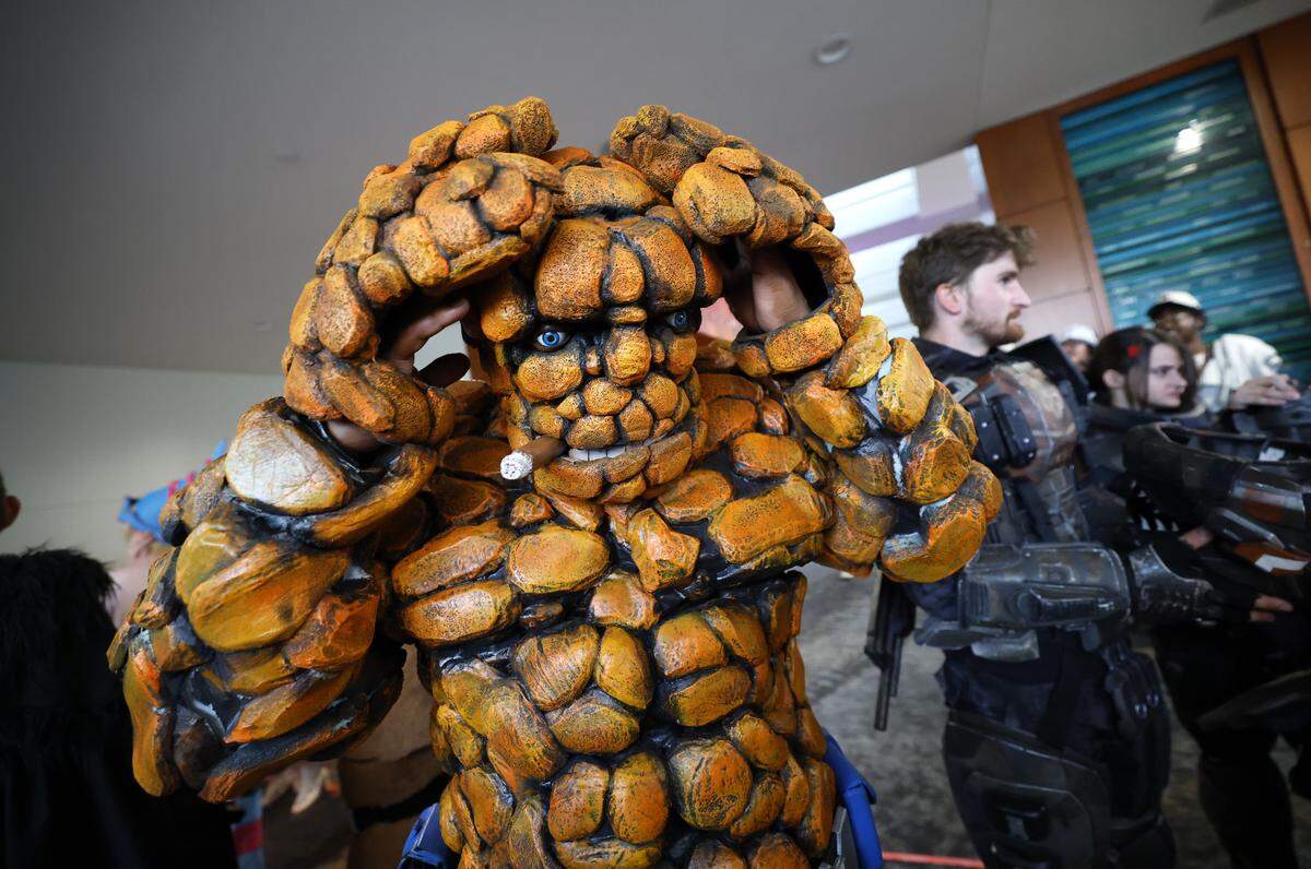 Mose Marshall of Efland puts on his head as The Thing before the costume contest at GalaxyCon Raleigh at the Raleigh Convention Center Saturday, July 26, 2025.