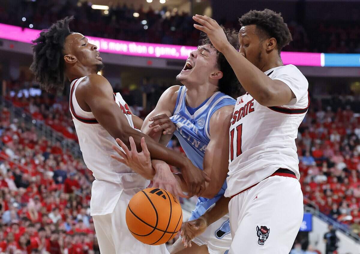 N.C. State’s Paul McNeil Jr. and Quadir Copeland pressure North Carolina’s Zayden High during the first half of the Wolfpack’s 82-58 win on Tuesday, Feb. 17, 2026, at Lenovo Center in Raleigh, N.C.