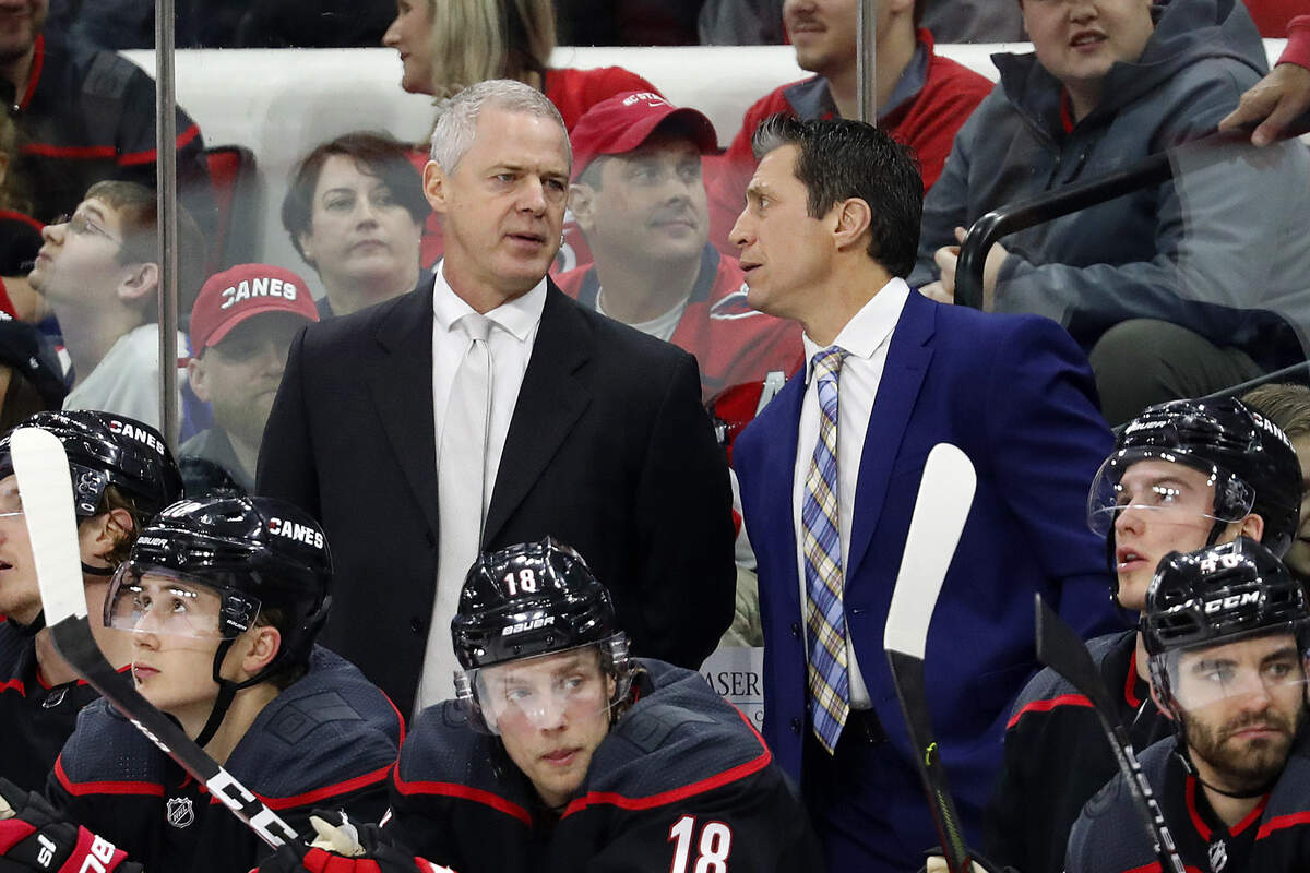 Carolina Hurricanes head coach Rod Brind ‘Amour speaks with assistant coach Jeff Daniels during the third period of an NHL hockey game against the Washington Capitals in Raleigh, N.C., Friday, Jan. 3, 2020. (AP Photo/Karl B DeBlaker)