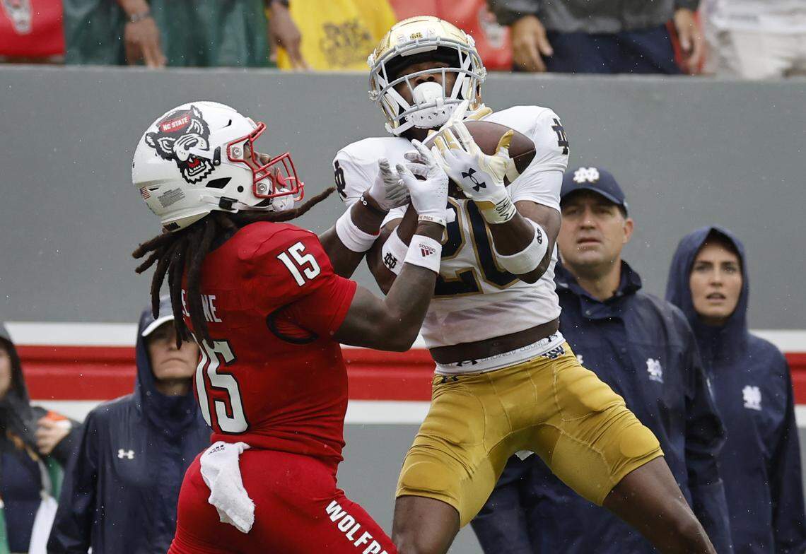 Notre Dame cornerback Benjamin Morrison (20) intercepts the ball intended for N.C. State wide receiver Keyon Lesane (15) during the first half of N.C. State’s game against Notre Dame at Carter-Finley Stadium in Raleigh, N.C., Saturday, Sept. 9, 2023.