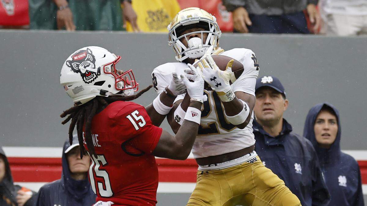 Notre Dame cornerback Benjamin Morrison (20) intercepts the ball intended for N.C. State wide receiver Keyon Lesane (15) during the first half of N.C. State’s game against Notre Dame at Carter-Finley Stadium in Raleigh, N.C., Saturday, Sept. 9, 2023.