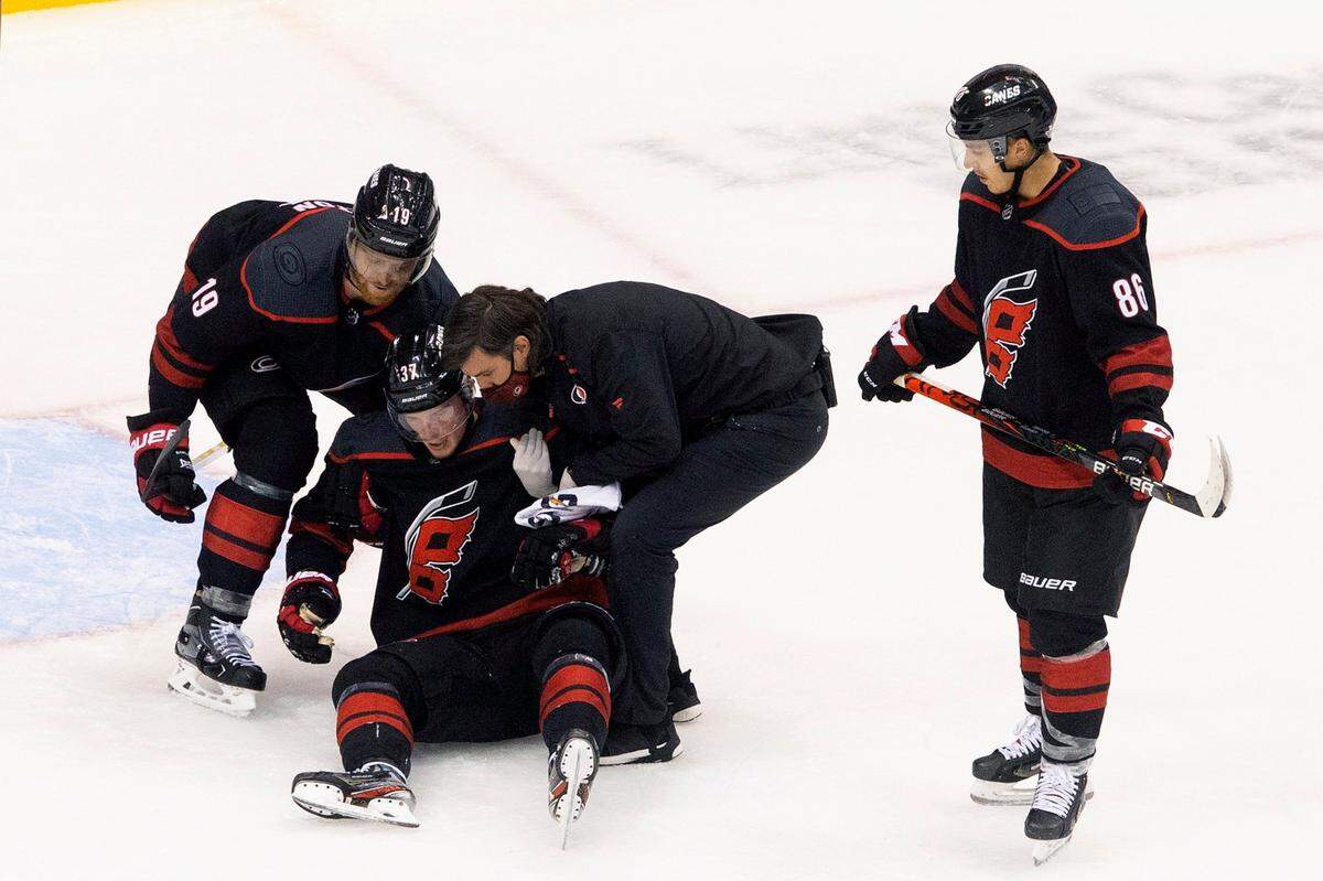 Carolina Hurricanes’ Andrei Svechnikov is helped up after being injured against the Boston Bruins during third period NHL Eastern Conference Stanley Cup playoff game in Toronto on Saturday, Aug. 15, 2020.