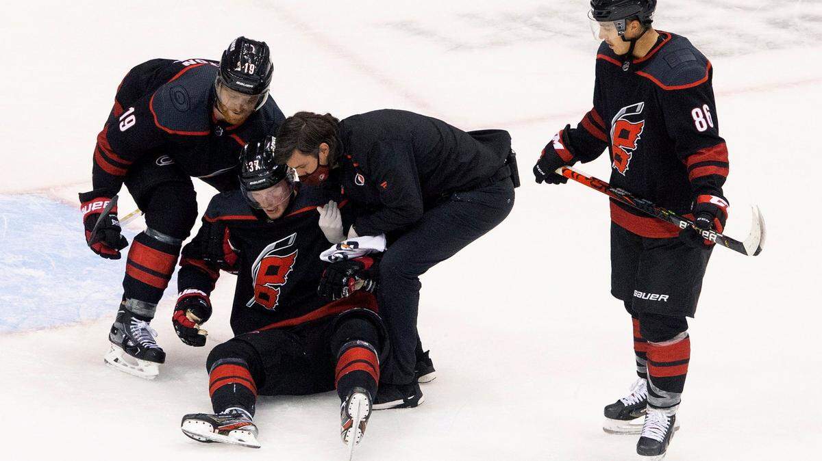 Carolina Hurricanes’ Andrei Svechnikov is helped up after being injured against the Boston Bruins during third period NHL Eastern Conference Stanley Cup playoff game in Toronto on Saturday, Aug. 15, 2020.