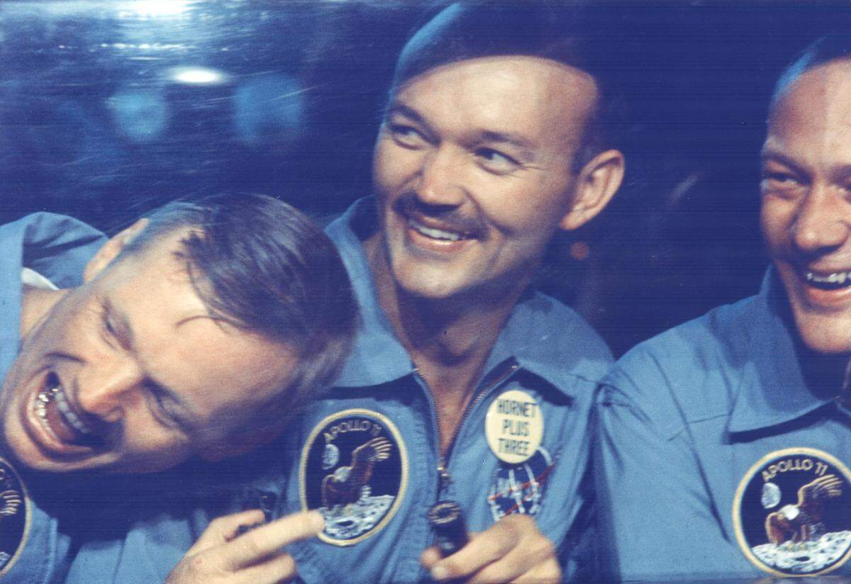 As seen in the PBS documentary series “Chasing the Moon,” Apollo 11 astronauts (L-R) Neil Armstrong, Michael Collins and Edwin E. Aldrin, Jr., share jokes with well-wishers on the other side of the window of their Mobile Quarantine Facility aboard the USS Hornet. July 24, 1969.