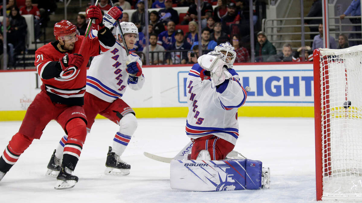 New York Rangers defenseman Adam Fox and goaltender Henrik Lundqvist (30), of Seweden, defend against Carolina Hurricanes right wing Nino Niederreiter (21), of the Czech Republic, while Hurricanes defenseman Dougie Hamilton, not shown, scores during the second period of an NHL hockey game in Raleigh, N.C., Thursday, Nov. 7, 2019. (AP Photo/Gerry Broome)