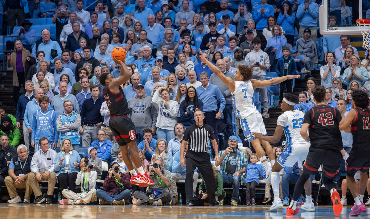 Stanford guard Jaylen Blakes (21) launches the game winning shot over North Carolina’s Seth Trimble (7) with :02 seconds to play to give Stanford a 72-71 victory over North Carolina on Saturday, January 18, 2025 at the Smith Center in Chapel Hill, N.C. Blakes, a former Duke guard, said after the game, ‘I was overjoyed.