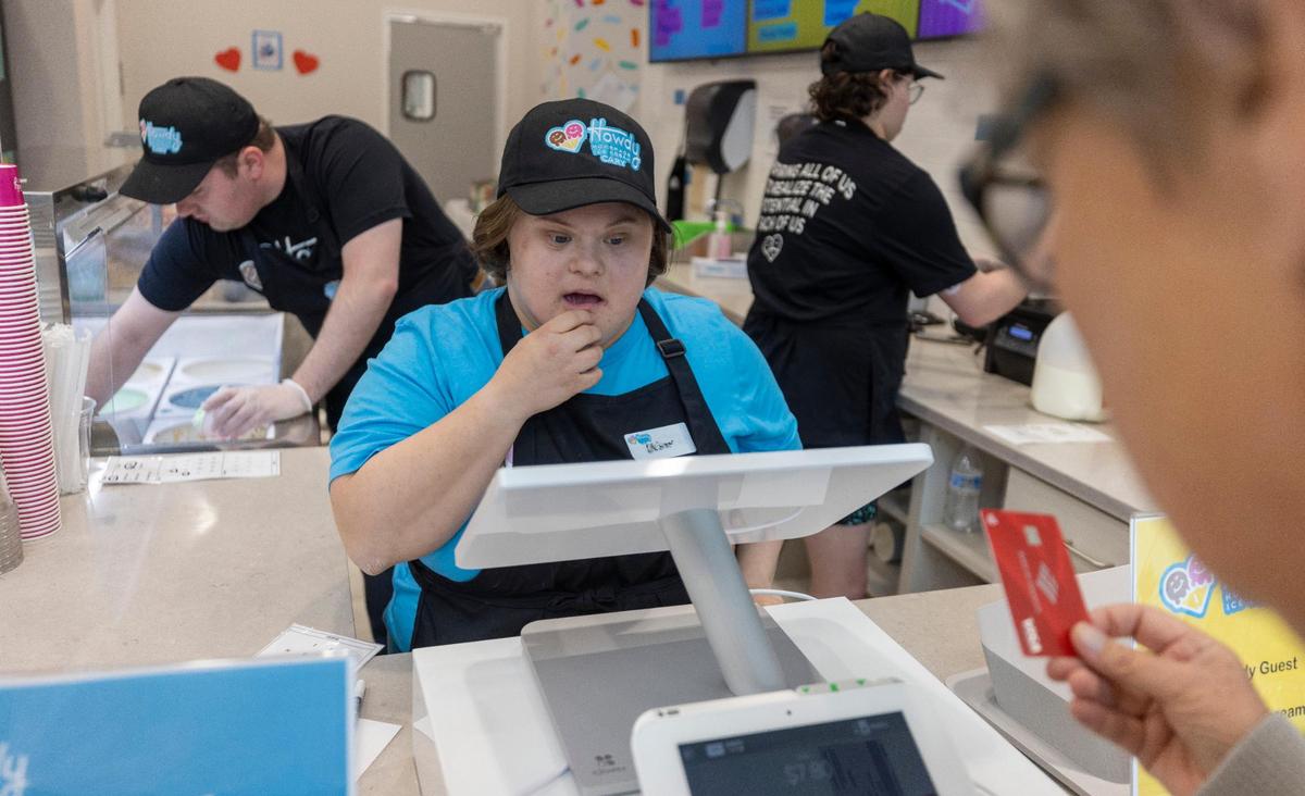 Abbey Goodwin takes an order from a customer at Howdy Ice Cream on Thursday, March 2, 2023 in Cary, N.C. The new ice cream shop offers employment opportunities to individuals with intellectual developmental disabilities, where they can use their talents