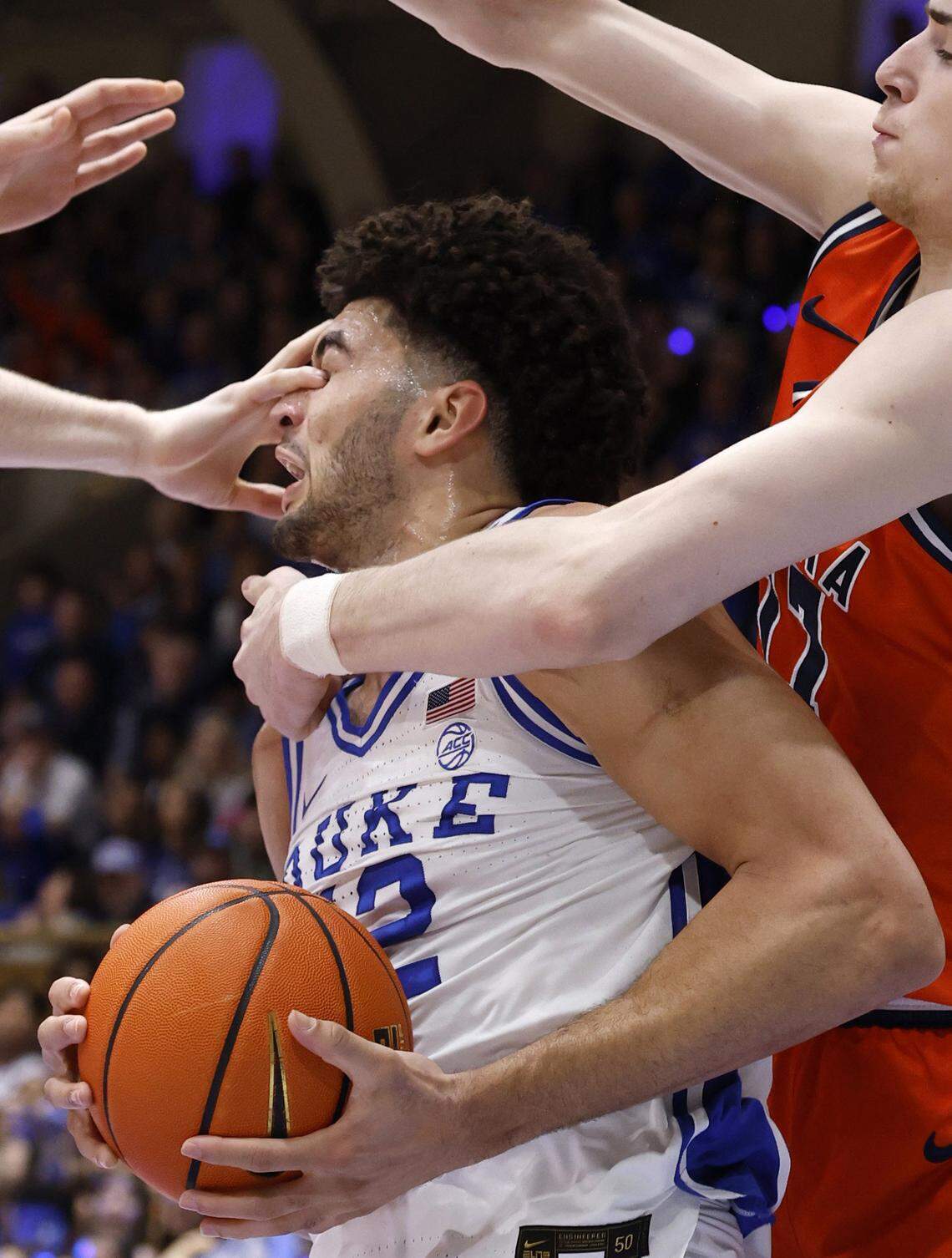 Duke’s Cameron Boozer (12) is hit in the eye as he moves towards the basket during the first half of Duke’s game against Virginia at Cameron Indoor Stadium in Durham, N.C., Saturday, Feb. 28, 2026. Boozer would leave the floor but returned a little bit later.