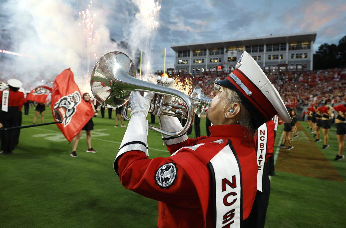N.C. State Marching Band member Lois Roegge, 58, and the band play as the Wolfpack football team take the field before N.C. State’s game against Virginia Tech at Carter-Finley Stadium in Raleigh, N.C., Saturday, Sept. 27, 2025.