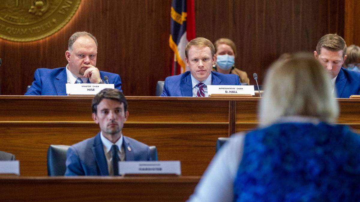 Top state redistricting legislators, Sen. Paul Hise, top left, and Rep. Destin Hall, top right, listen as several dozen members of the public address state lawmakers during a public comment hearing on Senate and House legislative redistricting maps Monday, Oct. 15, 2021 at the Legislative Building in Raleigh.