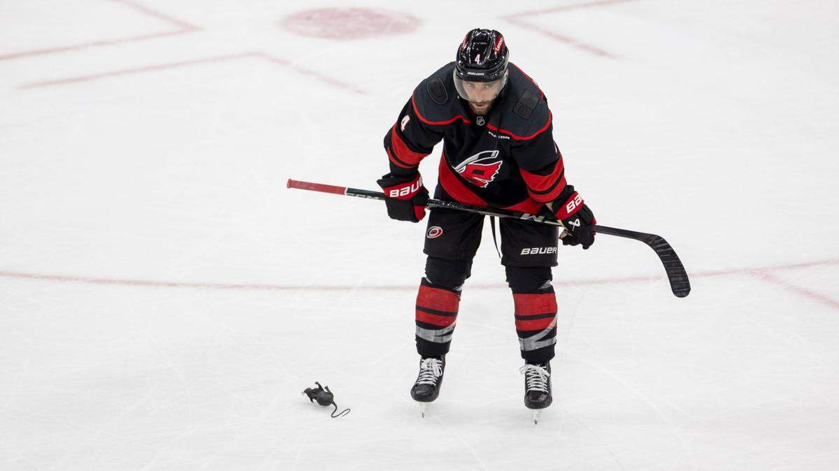 Carolina Hurricanes defenseman Shaye Gostisbehere (04) skates by a rat, a symbol of victory thrown on the ice by Florida Panthers fans, following their 5-3 victory over the Hurricanes on Wednesday, May 28, 2025 at Lenovo Center in Raleigh, N.C.