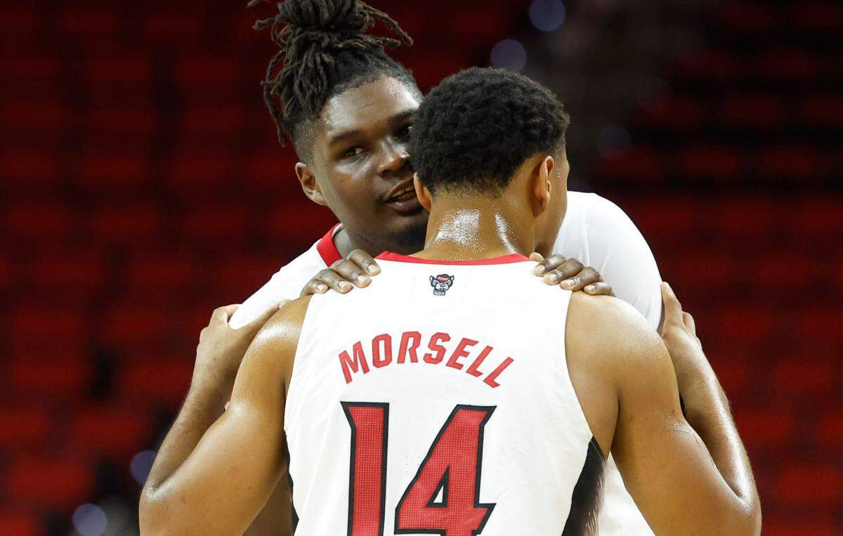 N.C. State’s DJ Burns Jr. (30) talks with Casey Morsell (14) during the second half of N.C. State’s 89-76 exhibition victory over Mount Olive at PNC Arena in Raleigh, N.C., Wednesday, Nov. 1, 2023.