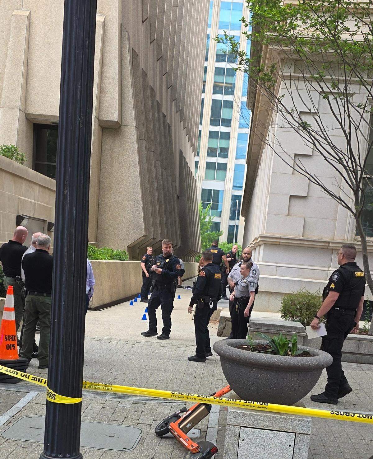 Raleigh police collect evidence after two attorneys were shot in an alley outside the Wake County courthouse on May 22, 2026.