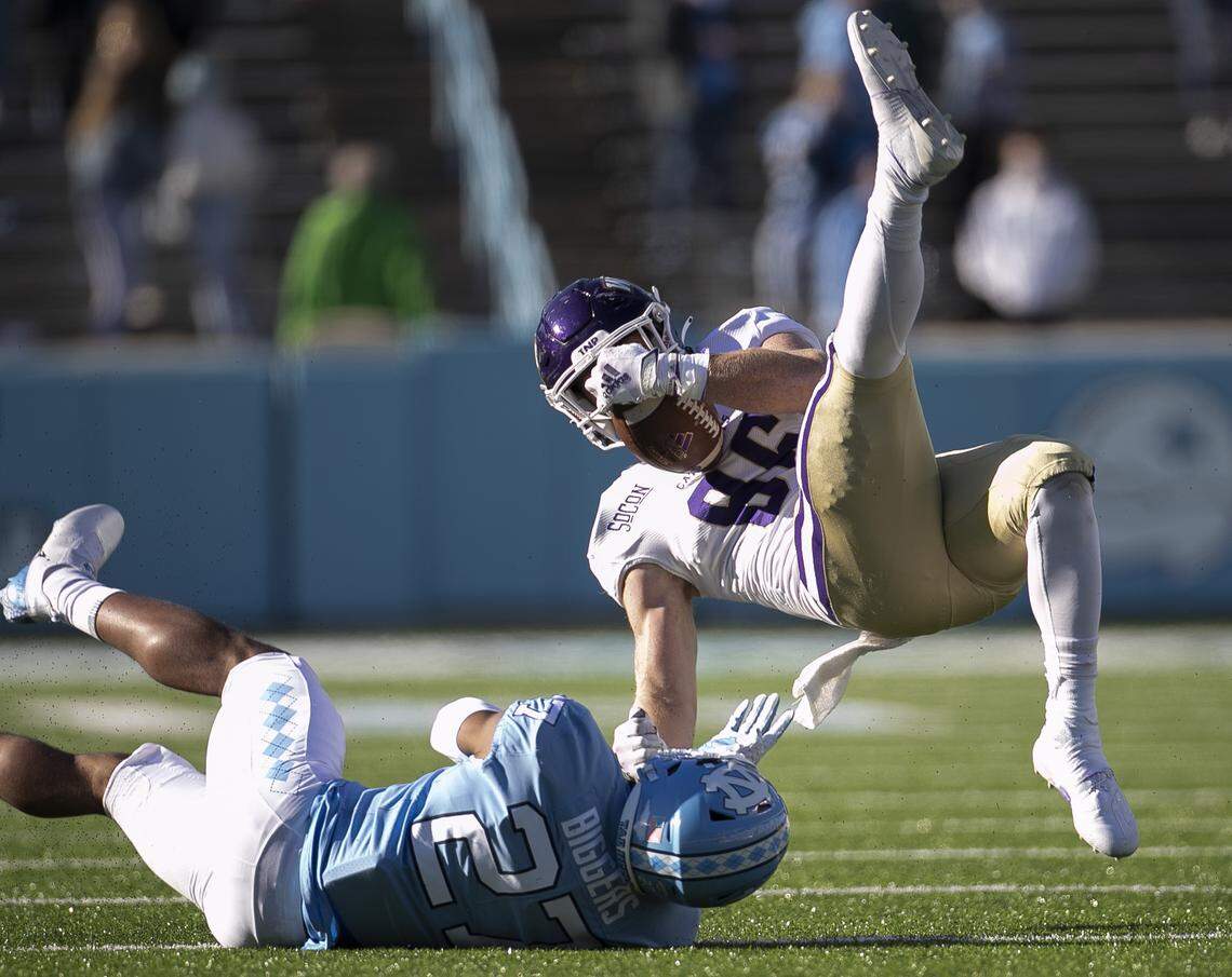 North Carolina’s Giovanni Biggers (27) stops Western Carolina’s Clayton Bardall (86) after a 13-yard pass receptions from quarterback Will Jones in the fourth quarter on Saturday, December 5, 2020 at Kenan Stadium in Chapel Hill, N.C.
