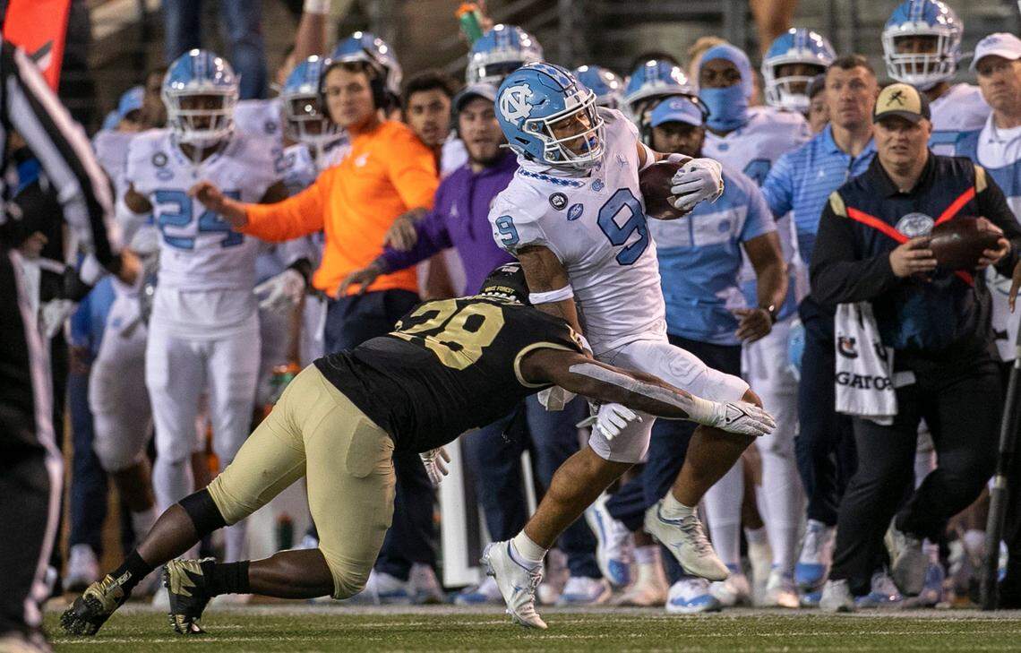 North Carolina’s Cam’Ron Kelly (9) returns an interception of a pass by Wake Forest quarterback Sam Hartman 23-yard in the fourth quarter to set up the game winning field goal on Saturday, November 12, 2022 at Truist Field in Winston-Salem, N.C.