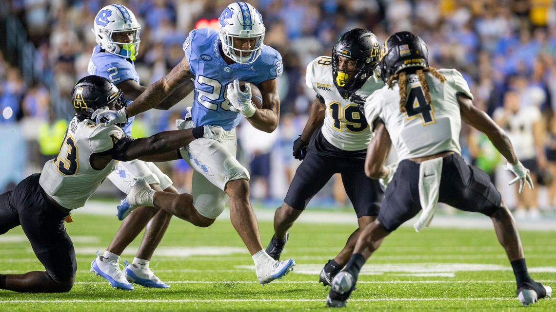 North Carolina running back Omarion Hampton (28) looks for running room against Appalachian State’s Derrell Farrar (33) on a 7-yard carry in overtime on Saturday September 9, 2023 at Kenan Stadium in Chapel Hill, N.C
